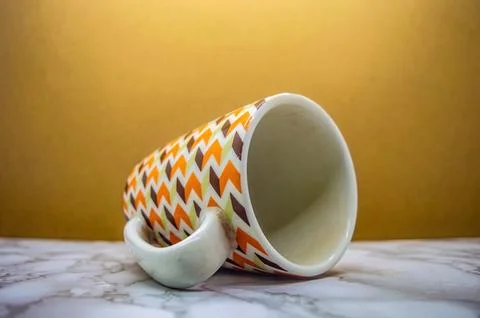 A stylish white ceramic mug with a vibrant retro zig zag pattern in brown, .. Stock Photos