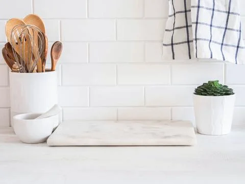 Stylish white kitchen background with kitchen utensils standing on wood cou.. Stock Photos