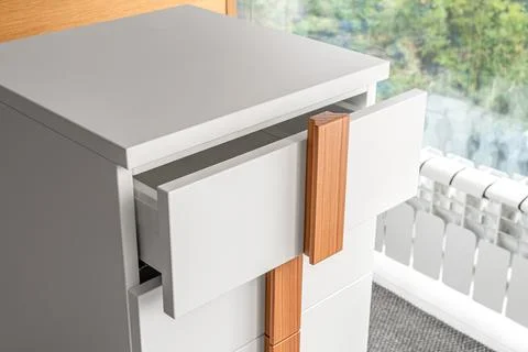 Stylish white office commode with open drawers closeup Foto stock