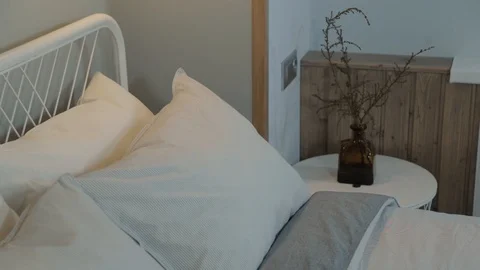 Stylish white pillows on the bed in a modern interior. 库存影片 120473700