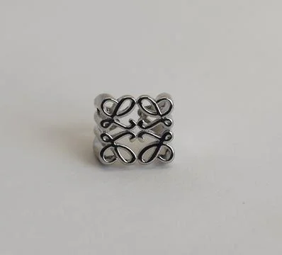 Stylish wide silver ring featuring artistic black cut-out design with intricate Stock Photos