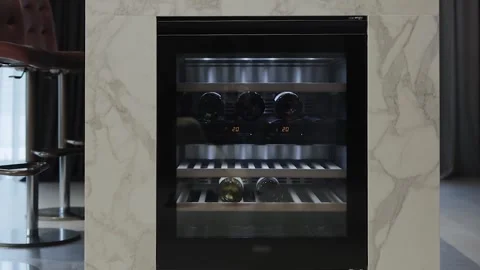 Stylish wine refrigerator with a modern and chic design in the kitchen Stock Footage 311253142