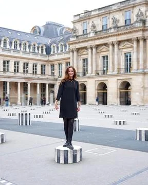 Stylish woman posing on art column in Paris Stock Photos