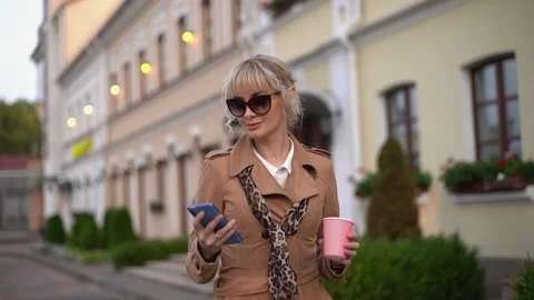 A stylish woman using smartphone while standing in city street. Stock Footage 153471008