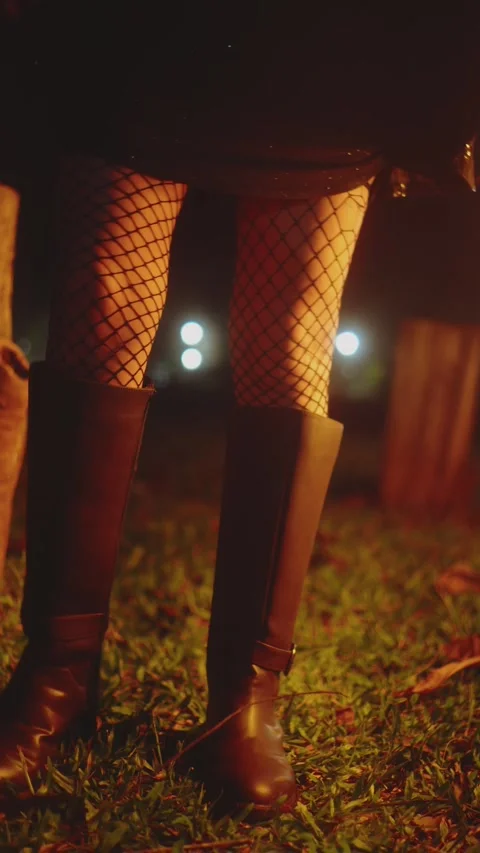 Stylish Woman's Boots in Park Evoking Nighttime Mystery and Serenity Stock Footage 327488437
