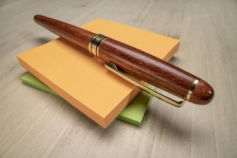 Stylish wooden pen and blank sticky note pads, Stock Photos
