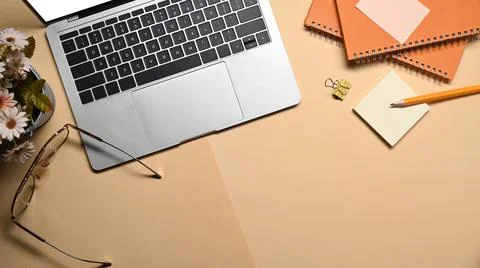 Stylish workplace, computer laptop, glasses, notebook and sticky note on beige 写真素材