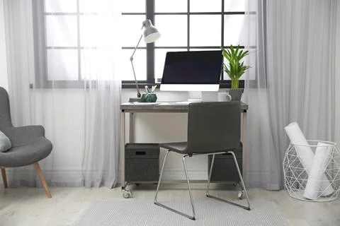 Stylish workplace with computer near window at home office. Space for text Stock-Fotos