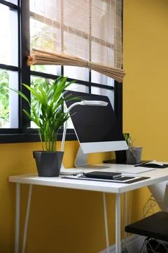 Stylish workplace with computer near window at home office. Space for text Stock-Fotos