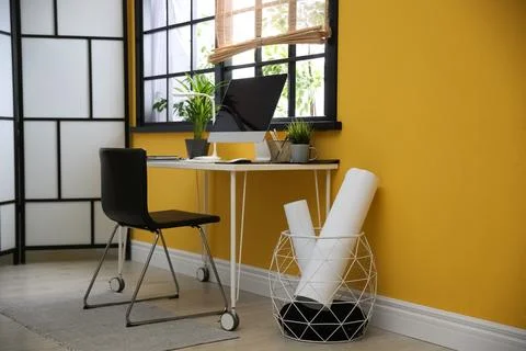 Stylish workplace with computer near window at home office. Space for text Stock Photos