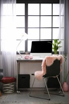 Stylish workplace with computer near window at home office. Space for text Stock Photos