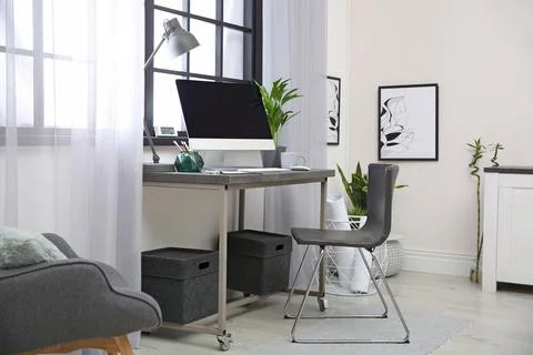 Stylish workplace with computer near window at home office. Space for text Stock-Fotos