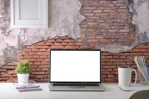 Stylish workplace with laptop computer, coffee cup, stationery and houseplant Foto stock