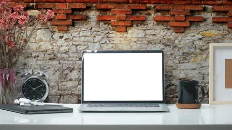 Stylish workplace with laptop computer, coffee cup and stationery on white .. Stock Photos