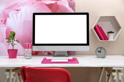 Stylish workplace with modern computer and pink elements indoors. Space for t 스톡 사진