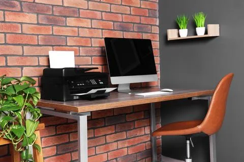 Stylish workplace with modern computer and printer at home Stock Photos