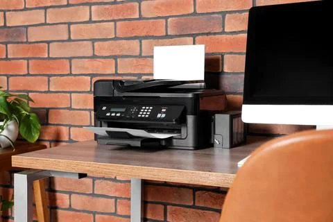 Stylish workplace with modern computer and printer at home Stock Photos