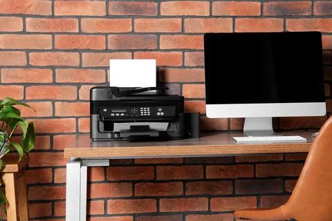 Stylish workplace with modern computer and printer at home Stock Photos