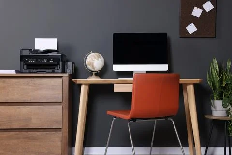 Stylish workplace with modern computer and printer at home Stock Photos