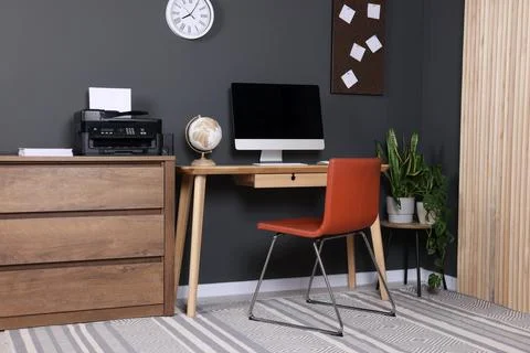 Stylish workplace with modern computer and printer at home Stock Photos