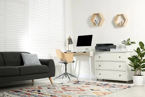 Stylish workplace with modern computer, printer and lamp 스톡 사진