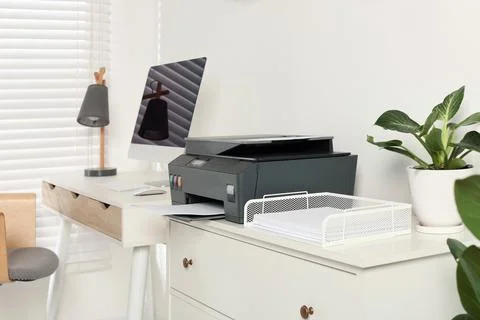 Stylish workplace with modern computer, printer and lamp 스톡 사진