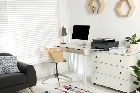 Stylish workplace with modern computer, printer and lamp Stock Photos