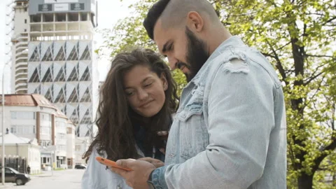 Stylish young couple in love using smartphone Stock Footage 95133961