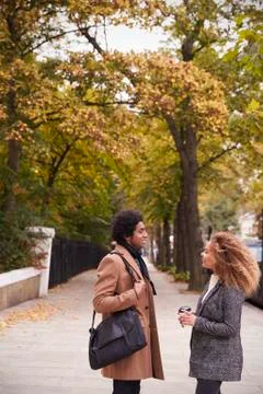 Stylish Young Couple Talking On Fall Street In City Stock Photos
