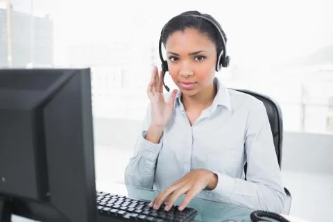 Stylish young dark haired operator answering a call Stock Photos