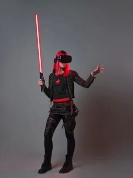 Stylish young gamer in a virtual reality helmet, playing in simulations, Stock Photos