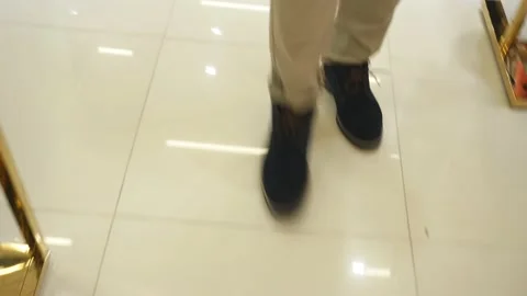 Stylish young guy walks around the clothing store in the Mall center. Video stock 117909042