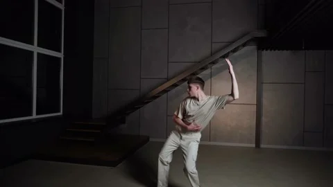 Stylish young man dancing in modern dance  and choreography on dark studio b Stock Footage 227551477