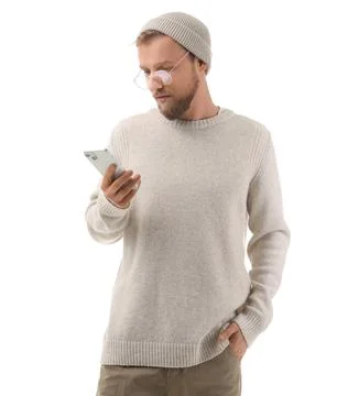 Stylish young man in eyeglasses using mobile phone on white background Stock Photos
