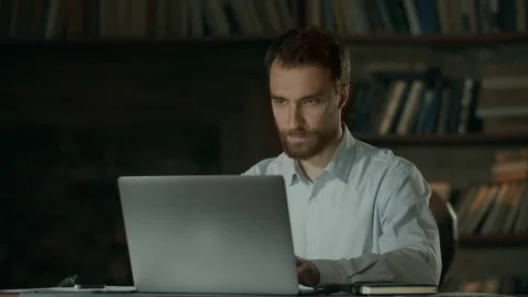 Stylish young man in office with loft style. Businessman makes notes on Stock Footage 246809488