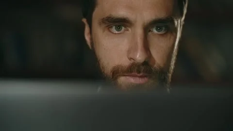 Stylish young man in office work on laptop or pc. Businessman makes notes on Stock Footage 247022569