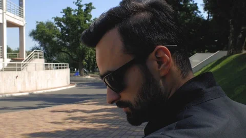 Stylish young man in sunglasses drinks tea or coffee from a disposable cup Stock Footage 113903854