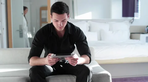 Stylish Young Man Using iPad/Tablet in Modern Setting Stock Footage 30368336