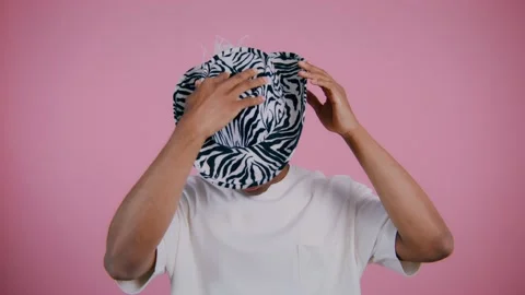Stylish zebra hat reveals a playful personality in vibrant setting Stock Footage 307935706