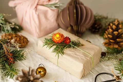 Stylish zero waste gifts on rustic table with fir branches, pine cones and .. Stock Photos