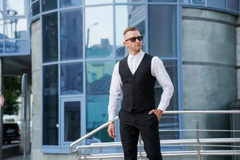 Stylishly Dapper: A Modern Man in Formal Attire against a Contemporary Urba.. Stock Photos