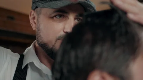 Stylishly dressed barber with a beard and a cap. Stock Footage 132283597
