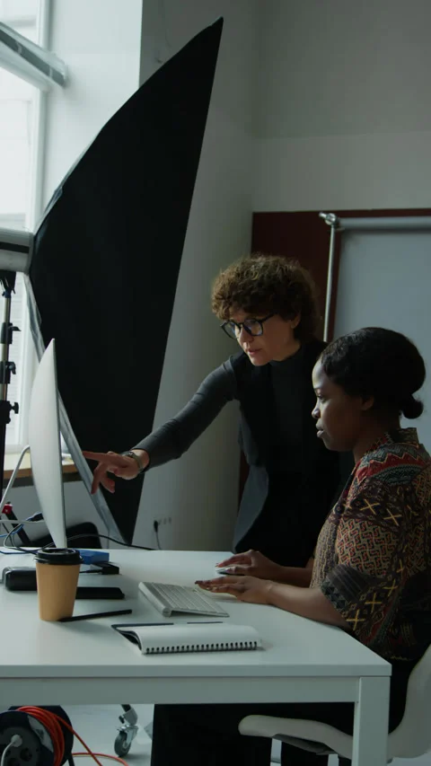 Stylist and Photographer Looking at Reference Picture on PC Video stock 257783945