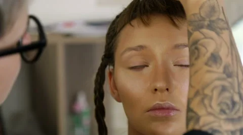 Stylist to apply makeup on the model's face Stock Footage 68649538