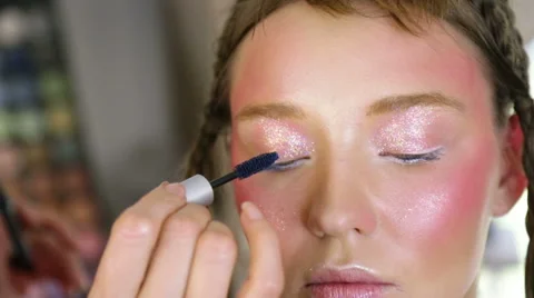 Stylist to apply makeup on the model's face Video stock 68851510