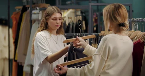 Stylist assisting client in clothing store fitting Stock Footage 321835904