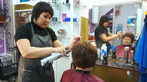Stylist with a client looking in the mirror Stock Footage 88471041
