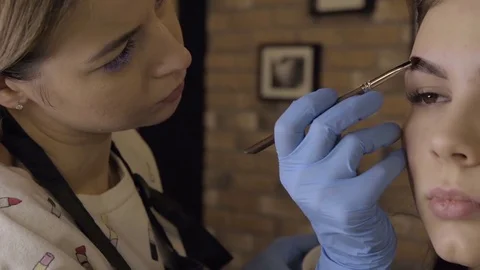 Stylist does beautiful eyebrows to the young beautiful woman. Beauty shop 스톡 동영상 73942434