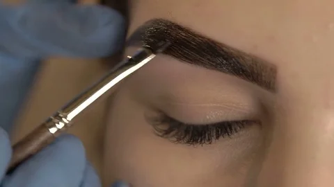 Stylist does beautiful eyebrows to the young beautiful woman. Beauty shop. Close 스톡 동영상 73944905