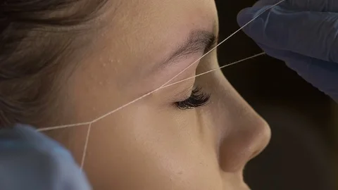 Stylist does beautiful eyebrows to the young beautiful woman. Beauty shop 스톡 동영상 73945373